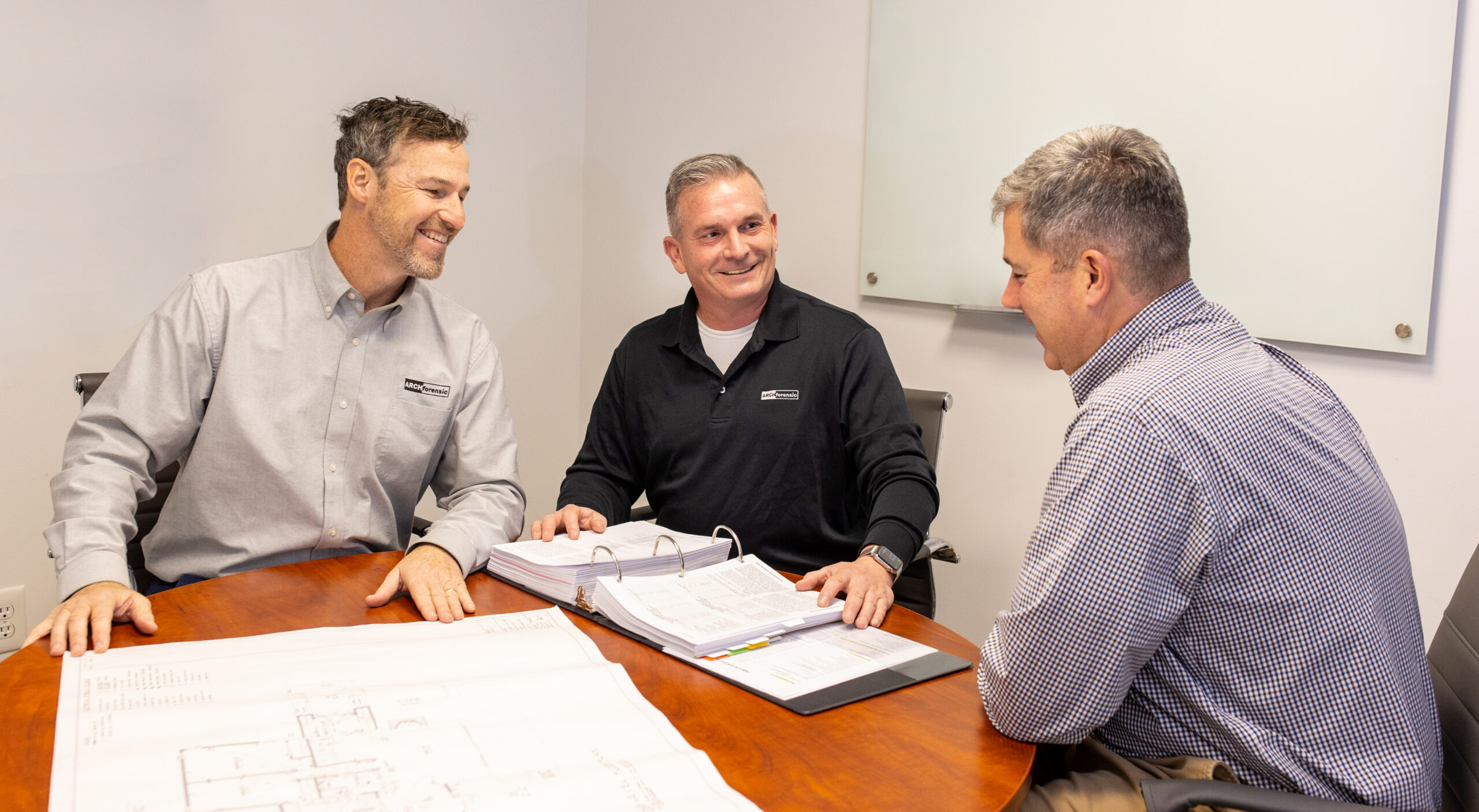 Christopher D. Ling, AIA, NCARB, Timothy P. Ronan, PE and Ken Warman reviewing architectural drawings and construction documentation in the office
